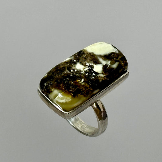 Dark marble-like amber ring