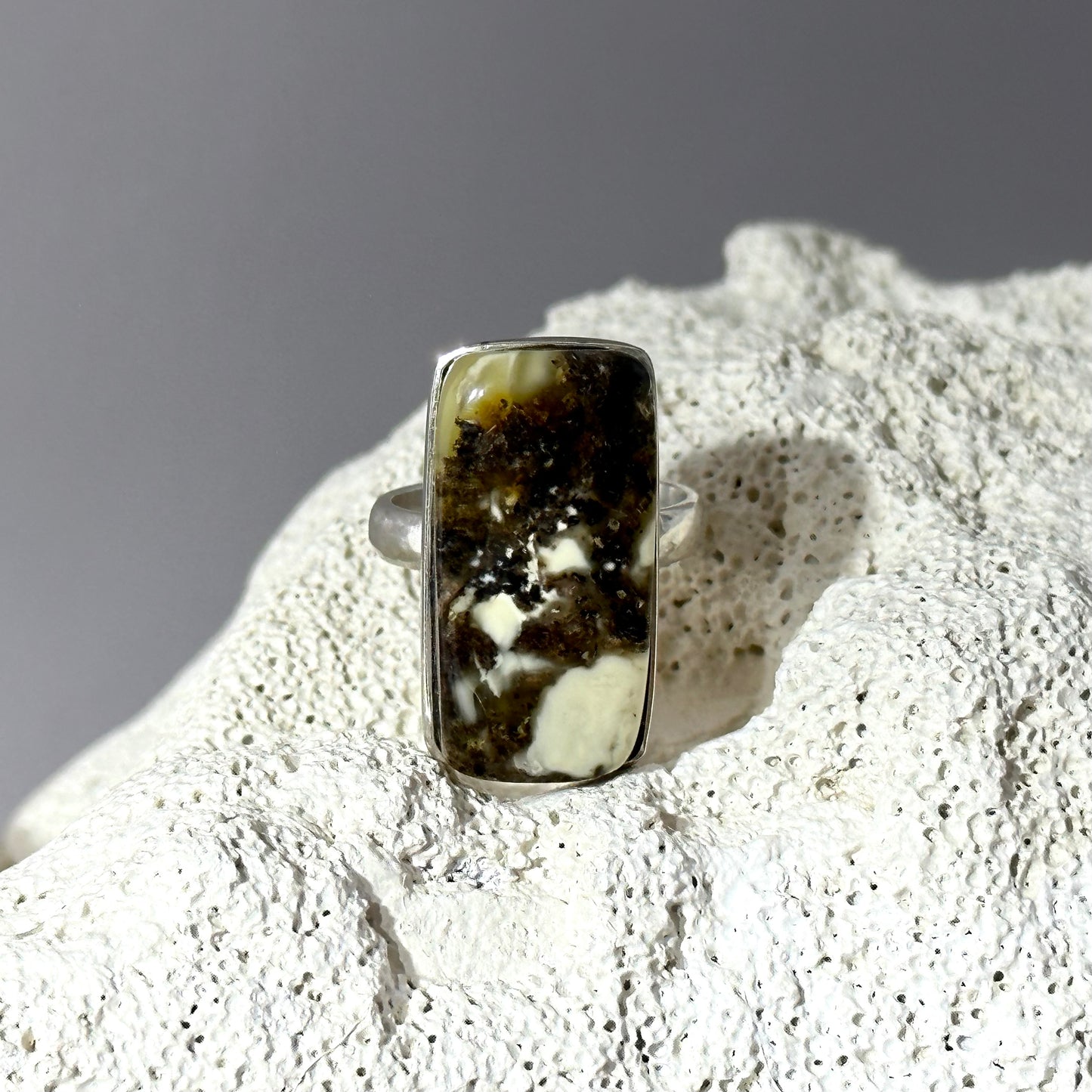 Dark marble-like amber ring