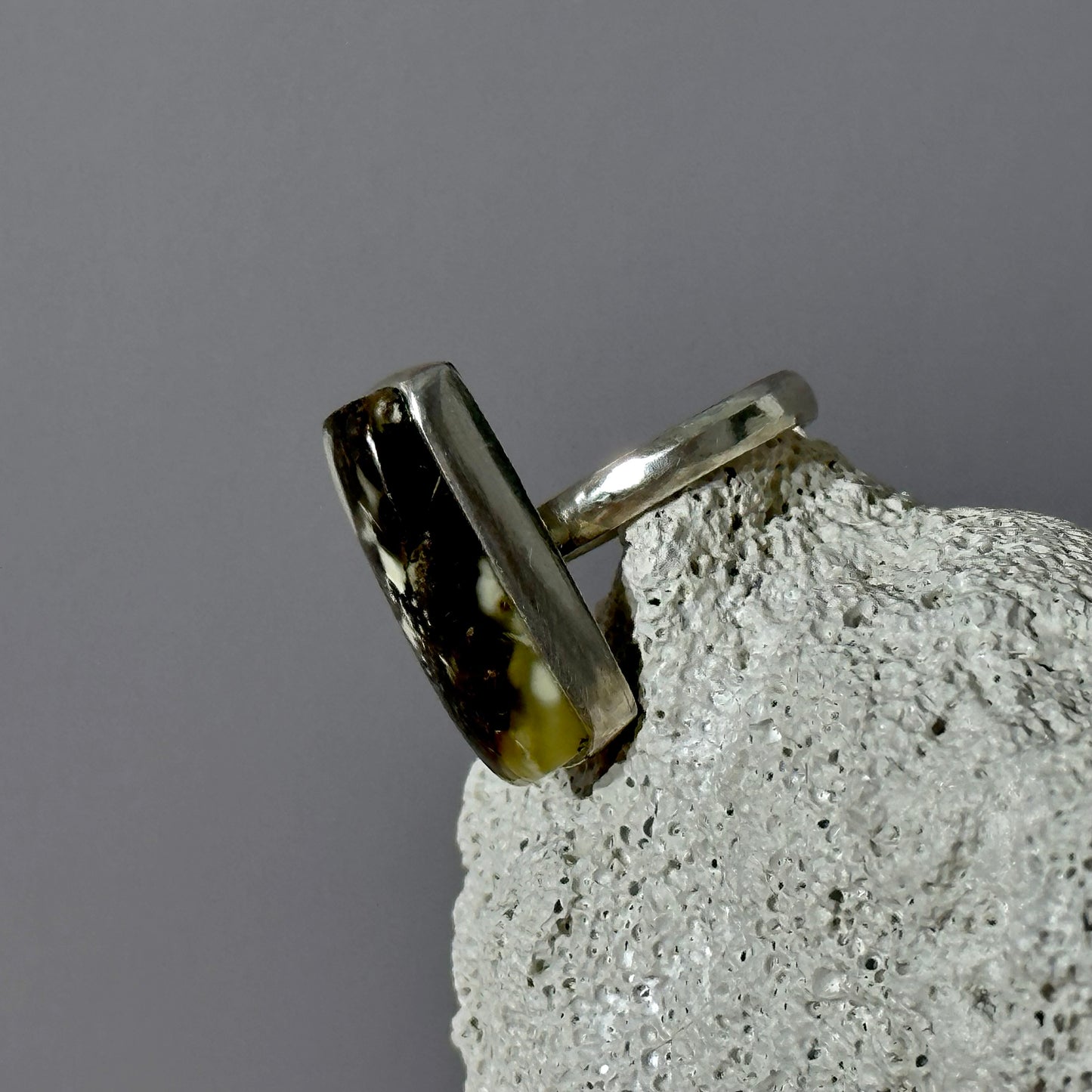 Dark marble-like amber ring