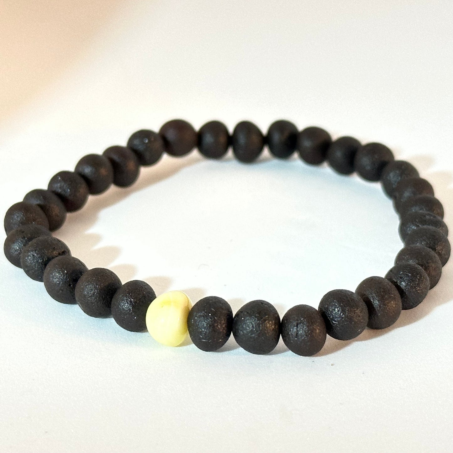 Dark amber bracelet with white accent