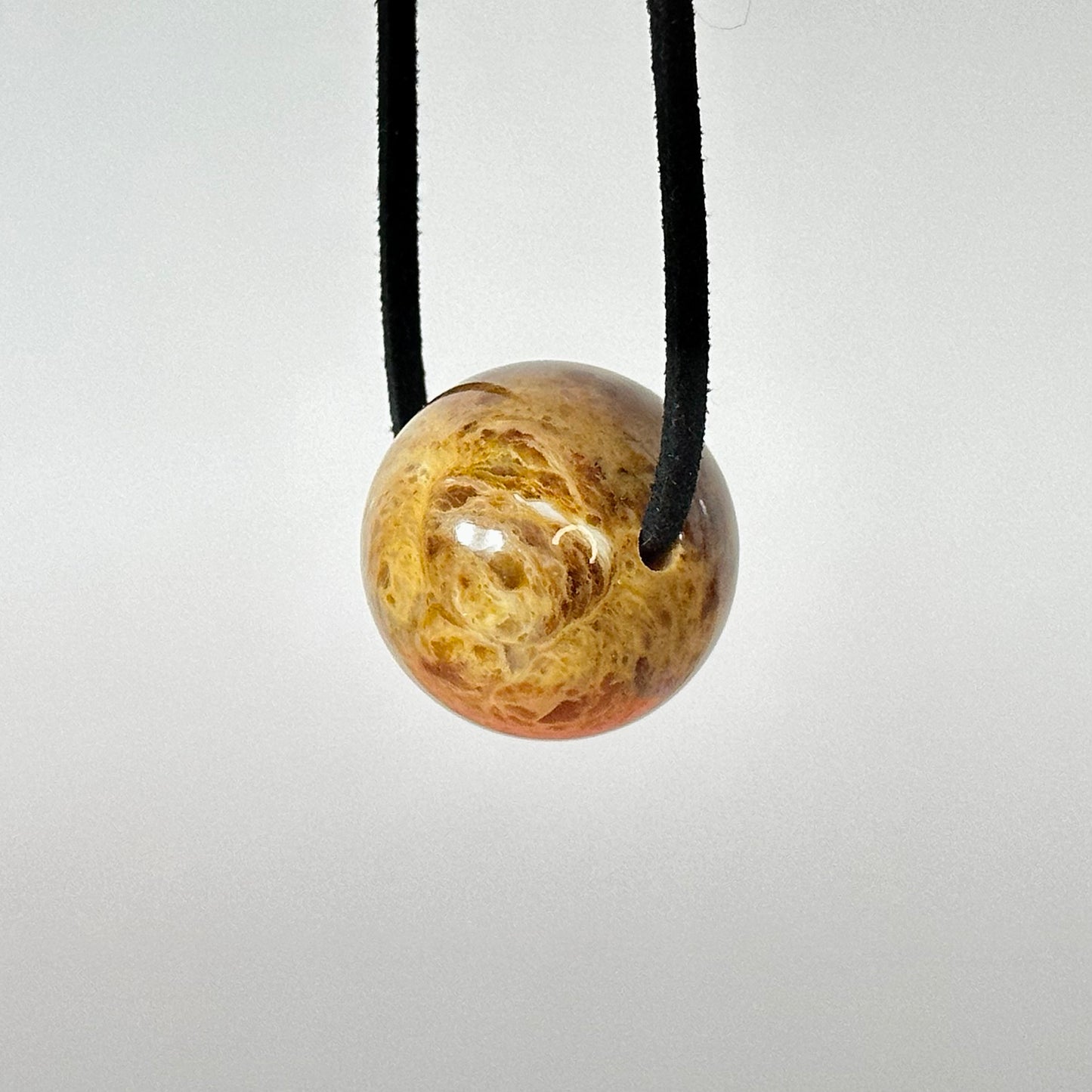 Versatile round amber pendant